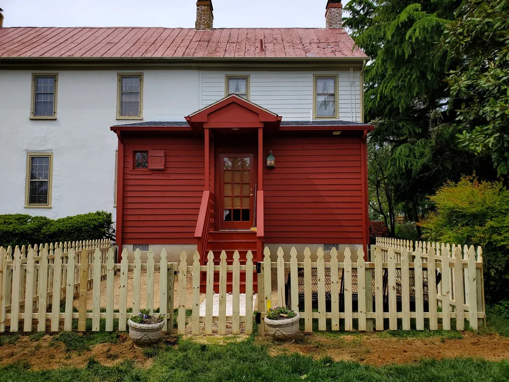 Completed farmhouse addition with red siding by Wright Contracting, photo 3 of 4
